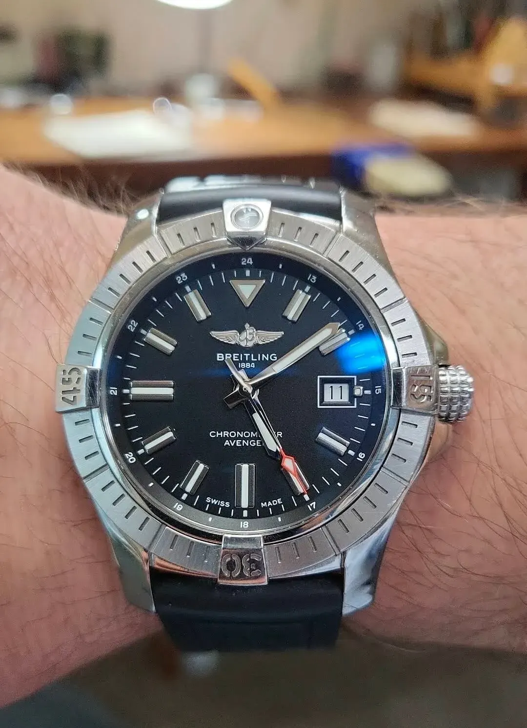A Breitling Avenger chronometer on a black rubber strap.