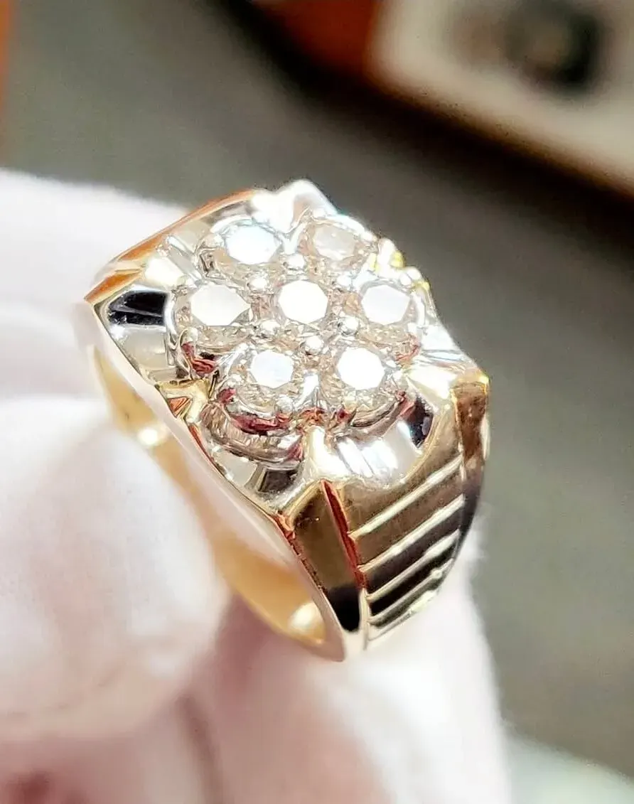 A men’s two-tone gold ring with a round diamond cluster face.
