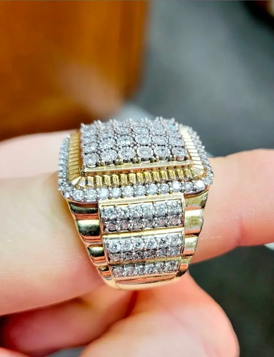 A men’s yellow-gold ring with a pavé diamond face.