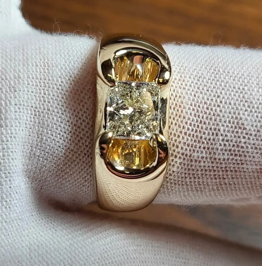 A yellow-gold band set with a radiant fancy-yellow diamond.